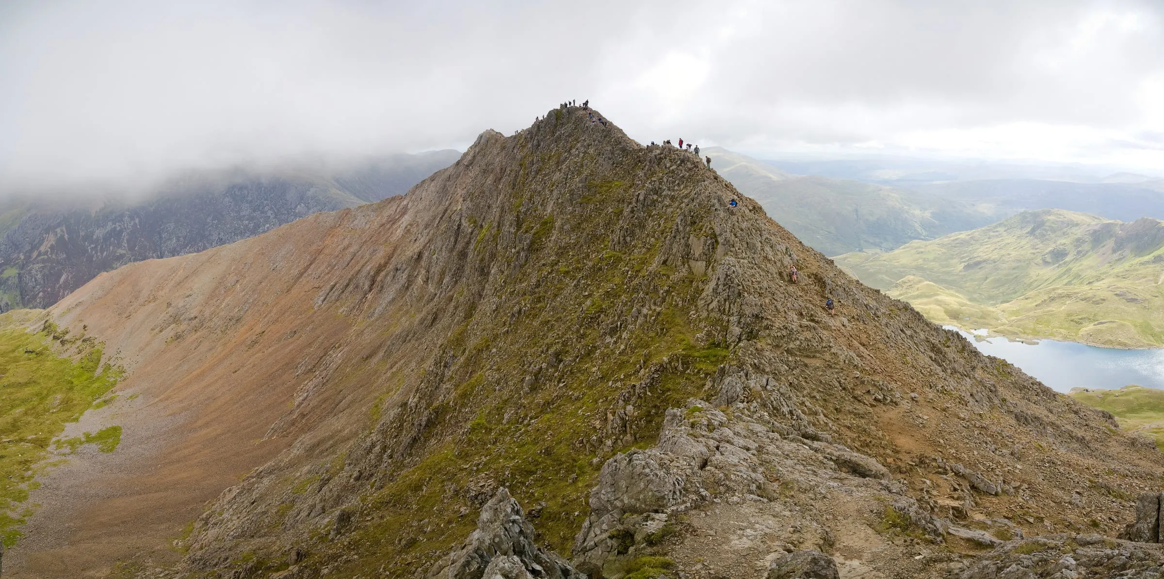 The Crib Goch ridge, walkers strung along the arête